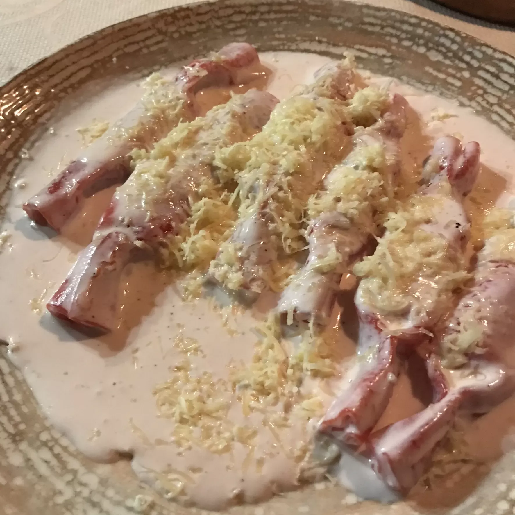 Karamele Zana, candy-shaped stuffed pasta in a creamy sauce with grated cheese