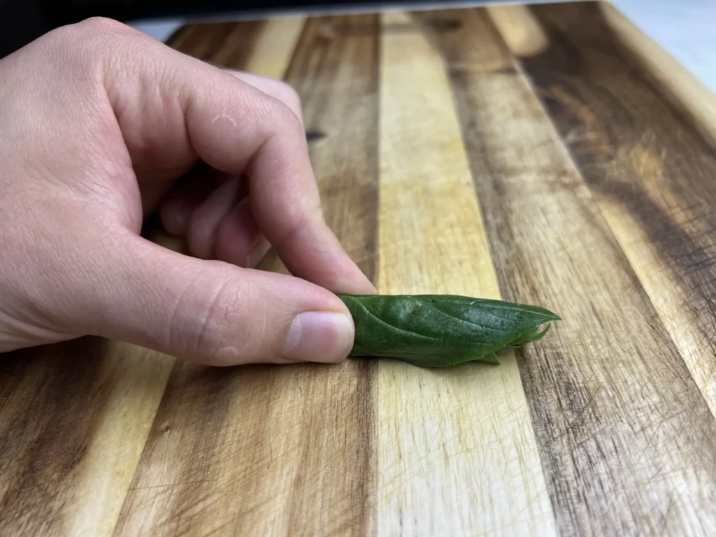 Roll the leaves of basil